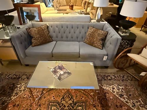 Tufted Grey Sofa with Tapered Black Wood Legs - $349
Modern Chrome and Mirror Cocktail Table - $279